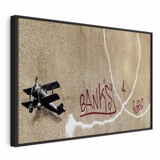 Obraz - Samolot Banksy (1-częściowy) - graffiti czerwone napisy na tle muralu 120x80 W ramie drewnianej czarnej