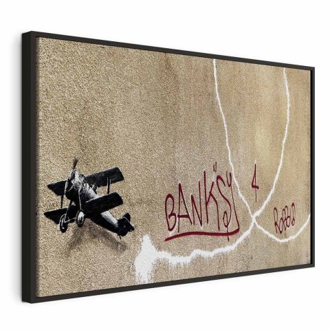 Obraz - Samolot Banksy (1-częściowy) - graffiti czerwone napisy na tle muralu 60x40 W ramie drewnianej czarnej
